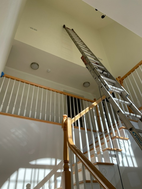 High-reach interior painting work in a Hudson, NY foyer